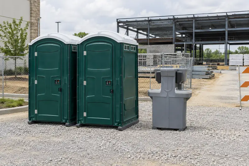 Illustrative portable toilet arrangement beside construction